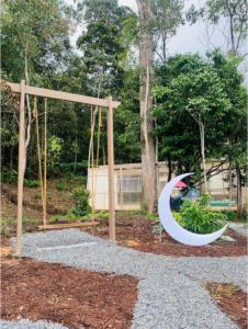 a swing set in a park with a playground at Kireina Genting Villa in Genting Highlands