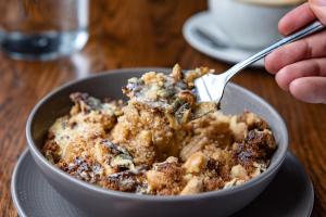 a person eating a bowl of food with a fork at The Bear in Bath