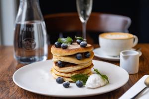 a stack of pancakes on a plate on a table at The Bear in Bath