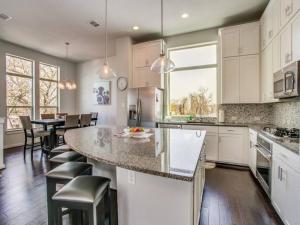 a kitchen with white cabinets and a large island at Elegant 3 BED Home Walk To Riverwalk/Pearl/St Mary in San Antonio