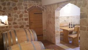 a wine tasting room with a table and a chair at Apartments Vlasic in Ston