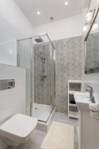 a bathroom with a shower and a toilet and a sink at Al. Wyzwolenia 14a by Homeprime in Warsaw