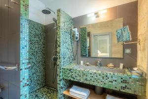 a bathroom with a sink and a shower at Boutique Hôtel Entraigues in Uzès