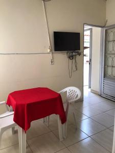 a room with a table with a red cloth on it at Recanto Magalhães in Barra do Garças