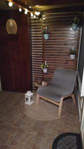 a chair sitting on a rug in a room at Havenly Loft in Mytilini