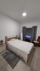 a bedroom with a large bed in a room at Apartamento da Antónia in Viseu