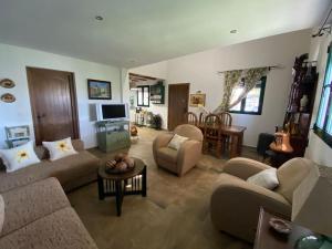a large living room with couches and a table at Fantastic Private Villa with pool near Ardales and Caminito del Rey in Ardales