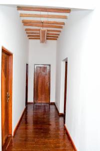 an empty hallway with white walls and a wooden ceiling at Ondo House in Nungwi