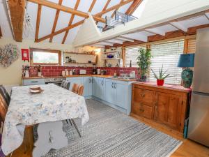 a large kitchen with a table and a kitchen with at The Lodge in Norwich