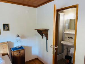 a bathroom with a sink and a toilet and a mirror at Hotel Sternen Worb in Worb