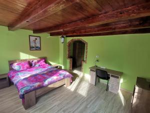 a bedroom with a bed and a desk and a television at Casa LUCA in Luncasprie +58 photos