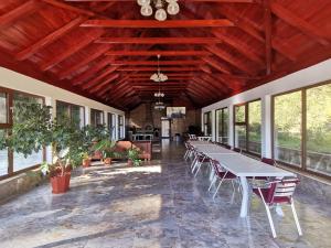 a large room with tables and chairs and windows at Casa LUCA in Luncasprie