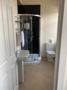 a bathroom with a shower and a sink and a toilet at The New Brighton Hotel in New Brighton