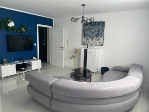 a living room with a couch and a tv at MY PLACE in Slavonski Brod