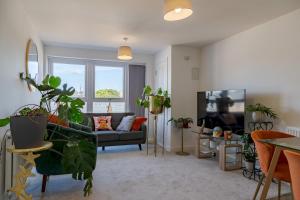 a living room with a couch and lots of plants at Pass the Keys NEW Chic 2 Bed Pad Central Free Parking in Birmingham