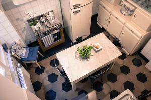 a kitchen with a table with a plant on it at IN CANNETO...Genova nel cuore. in Genoa