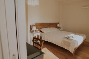 a small bedroom with a bed and a desk at Casalloro in Valdagno