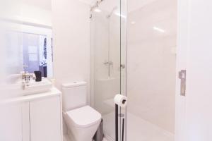 a white bathroom with a toilet and a shower at ON Apartments - Lapa Deluxe in Porto