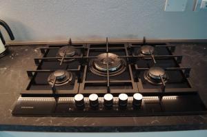 a stove top with several pots and pans on it at My Sirmione Beach Apartment Superior in Sirmione