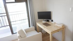 a room with a desk with a computer and a chair at SYOGA A house, next to natural park in Osaka