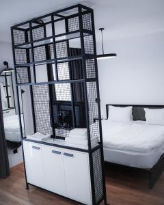 uma gaiola de pássaros preto e branco ao lado de uma cama em Kazbegi Apartments em Stepantsminda