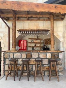 a bar with stools and a stone wall at Nujel'm Cappadocia in Urgup