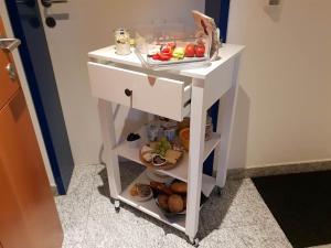 a small white cart with fruits and vegetables on it at Ammann Marika in Vandans