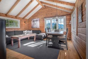 a living room with a table and a couch at Økslevegen 2 in Stranda