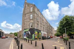 a bus is parked in front of a building at City Centre 2 Bedroom Main Door Apartment in Edinburgh