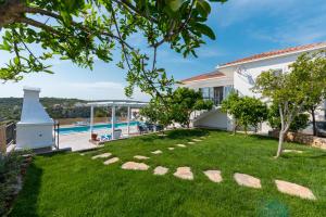 a house with a yard with a swimming pool at LUXURY VILLA ŠENTADA in Vinišće