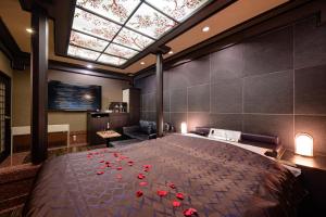 a bedroom with a large bed with red roses on it at Hotel Metro (Adult Only) in Yokohama