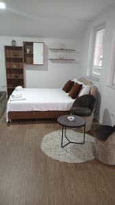 a bedroom with a bed and a coffee table at Sleep and drive No5 in Sarajevo