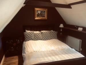 a bedroom with a bed with a black wall at Tudor House - Double Room - Shared Bathroom in Goffs Oak