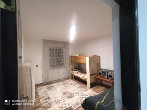 a small room with a bed and a table in a room at Xanbulan_Home in Aşağı Apu