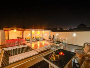 a patio with a table with food on it at night at Samira Group & Spa in Marrakesh