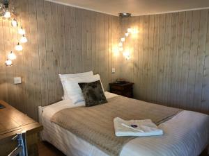 a bedroom with a bed with two towels on it at The Walnuts Country House in West Row