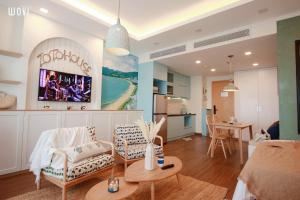 a living room with a couch and a table at FLC SEA TOWER - 4 SEASONS Apartment in Quy Nhon