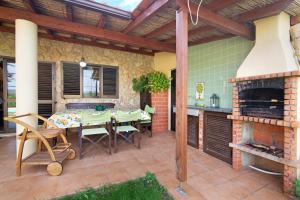 a patio with a table and a fireplace at Casa Rústica in Silves