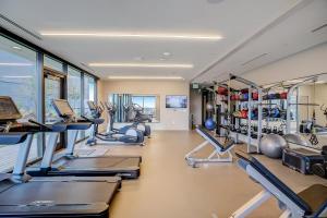 a gym with rows of treadmills and machines at Natiivo in Austin