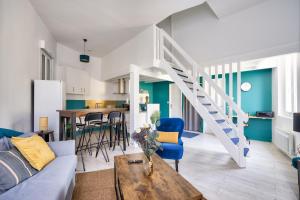 a living room with a couch and a staircase at Bordeaux : superb apartment near St-Jean station in Bordeaux