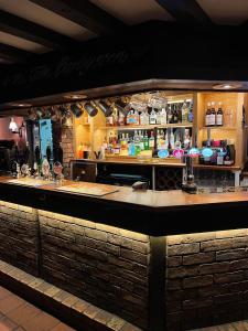 a bar in a restaurant with a counter at John Barleycorn in Duxford