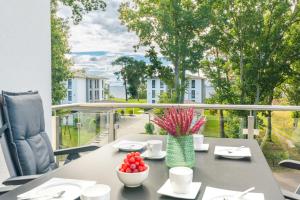een tafel op een balkon met uitzicht op de straat bij Apartment "Sonnendeck" - Haffresidenz in Zirchow