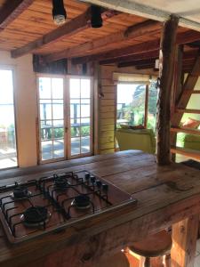 a stove top oven sitting inside of a kitchen at Cabaña Rustica en lagunillas con vista al mar in Navidad
