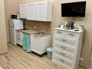 a kitchen with a sink and a white refrigerator at Core&Core in Naples