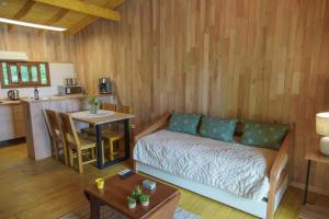 a living room with a couch and a table at CHACRA LA ANYTA in Nueva Carrara