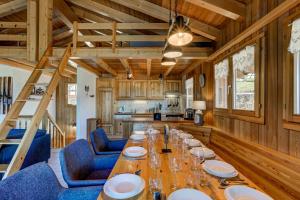 a dining room with a long table and blue chairs at Chalet Bellevue in La Tzoumaz +18 photos