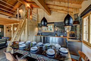 a kitchen with a table and chairs in a cabin at Chalet Cabana Luna in La Tzoumaz