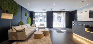 a living room with a couch and a table at Ilunion Almirante in Barcelona