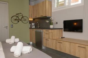 a kitchen with a bike hanging on the wall at Aperto Apartments in Mýkonos City