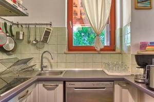 kuchnia ze zlewem i oknem w obiekcie Villa Agatha w mieście Krnica